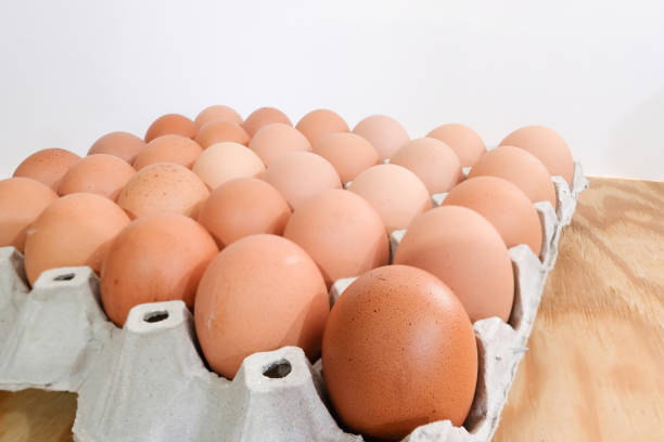 istock A pack of eggs on wooden background. 860144964