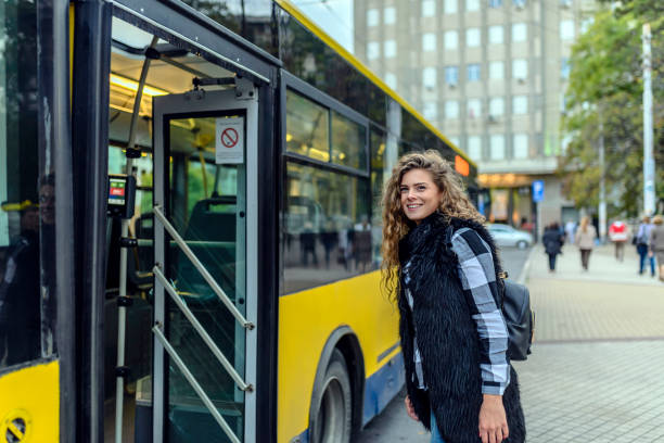 istock Young woman enters bus 860146494