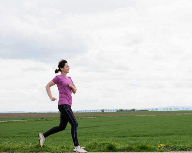 istock woman jogging outdoors 860148656