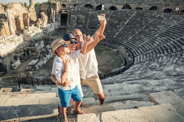 Young positive family take a self photo on the antique amphitheater in Side, Turkey Young positive family take a self photo on the antique amphitheater in Side, Turkey rome italy photos stock pictures, royalty-free photos & images