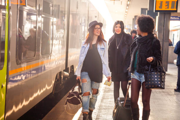 istock Friends at train station platform, tourist and commuters arriving 860151998