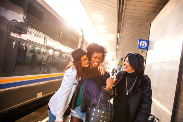 istock Friends at train station platform, tourist and commuters arriving 860152020