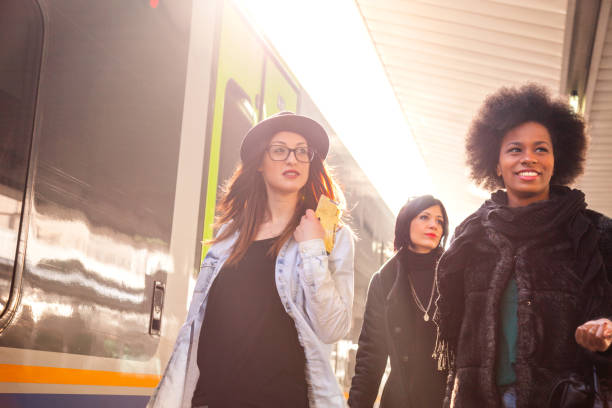istock Friends at train station platform, tourist and commuters arriving 860152034