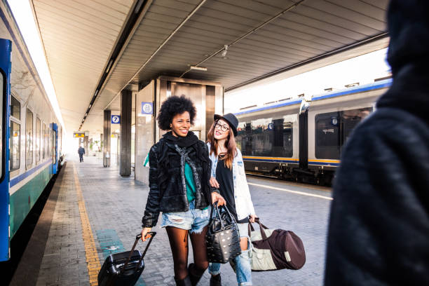istock Friends at train station platform, tourist and commuters arriving 860152174
