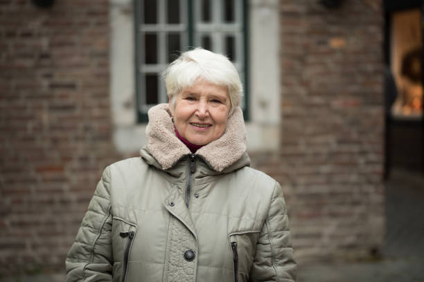 istock Elderly woman in winter clothes 860152538