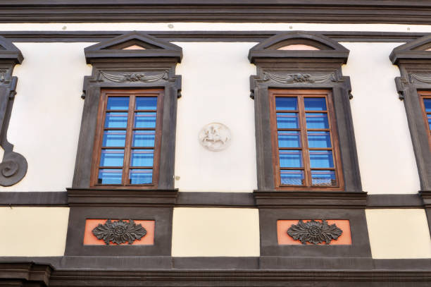 istock Two old windows in black decorative frame in the Vilnius street, Lithuania. 860161662