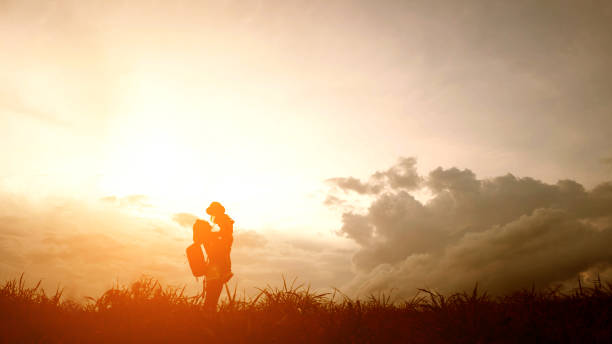 istock Silhouette of A mother and son playing outdoors at sunset. 860165438