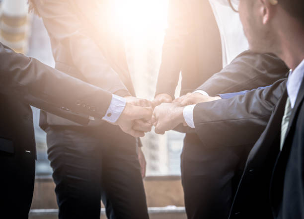 istock Business people group of hands making fist bump teamwork Join Hands Support together successful Concept. 860165452
