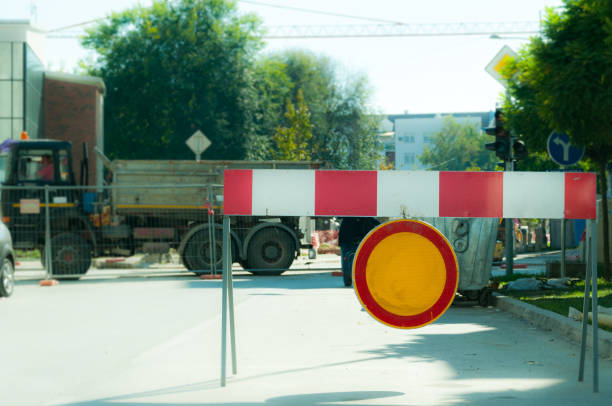 istock Work ahead construction site warning sign with barricades on the street 860168758
