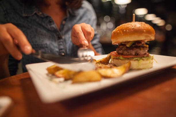 istock Woman eating some burger 860169580