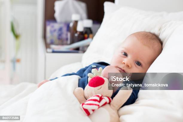 Cute Newborn Baby Boy Lying In Bed With Cold Stock Photo - Download Image Now - Baby - Human Age, Illness, Cold And Flu