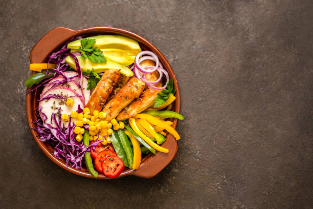 istock Grilled chicken, cabbage, pepper, avocado, tomato, greens, buddha bow 860172936