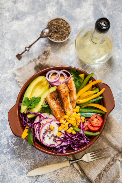 istock Grilled chicken, cabbage, pepper, avocado, tomato, greens, buddha bow 860173162