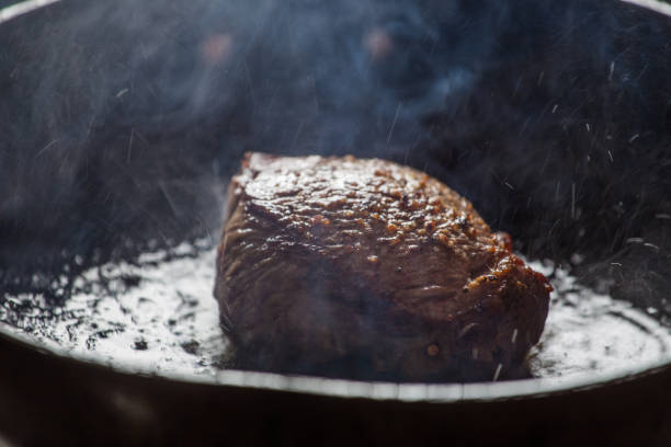 istock Piece of steak being fried in a pan. 860175456