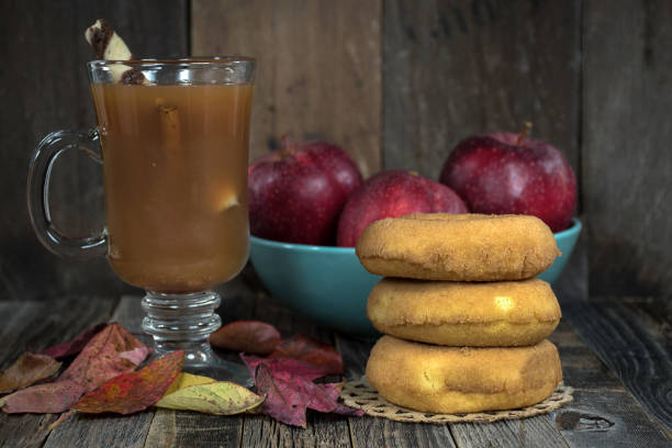 istock apple cider and leaves with donuts on wood 860179918