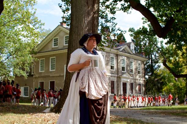 a revolutionary war re-enactor portraying a female camp follower takes part in the 240th anniversary reenactment of the battle of germantown - colonial re enactor imagens e fotografias de stock