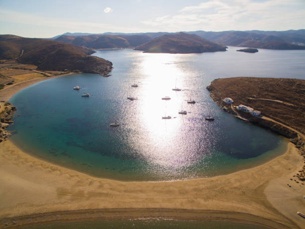 Group of sailboats moored at beautiful bay on amazing Colona beach on Kythnos island at Cyclades, Greece