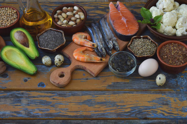 istock Composition of products containing unsaturated fatty acids Omega 3 - fish, nuts, avocado, eggs, soybeans, flax, pumpkin seeds, chia, hemp, cauliflower, dill, vegetable oil. Top view. Healthy food 860183492