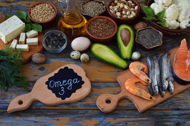istock Composition of products containing unsaturated fatty acids Omega 3 - fish, nuts, tofu, avocado, egg, soybean, flax, pumpkin seeds, chia, hemp, cauliflower, dill, vegetable oil. Top view. Healthy food 860184058