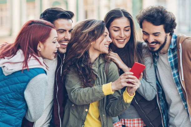 istock Group of friends looking at a mobile phone 860187940