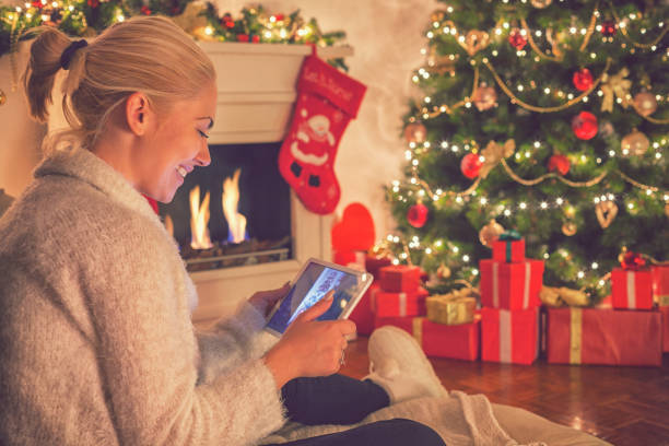 istock Young beautiful girl using digital tablet on Christmas night 860216956
