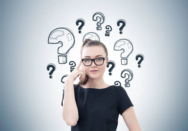 istock Serious businesswoman, glasses, question marks 860217036