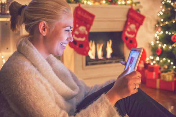 istock Young beautiful girl using digital tablet on Christmas night 860217200