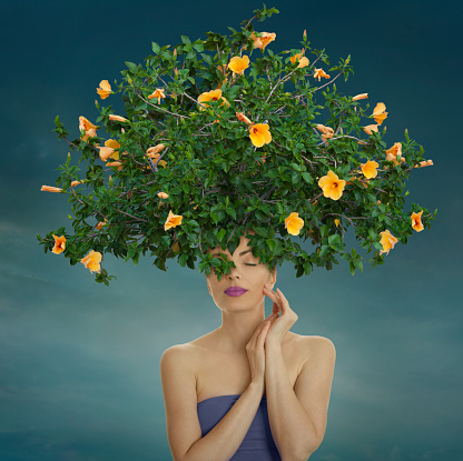 Woman with yellow hibiscus bush hairstyle.