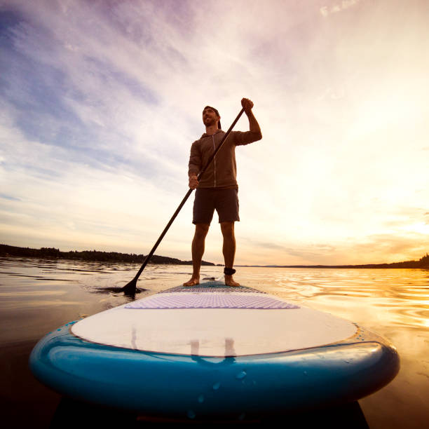 istock Man Riding Paddleboard on Puget Sound At Sunset 860217766