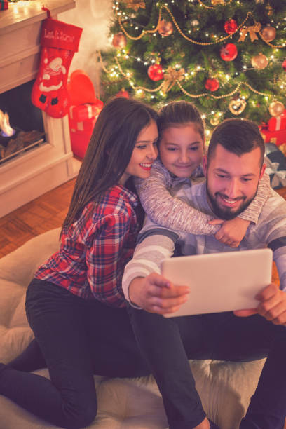 istock Smiling Family Using Digital Tablet on Christmas Eve 860220996