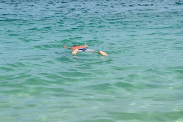 istock man lying on the water face down 860226410