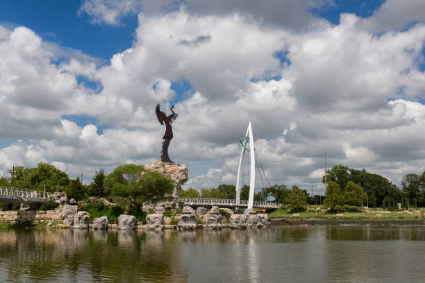 Wichita, Kansas, USA - August 13, 2017: Keeper of the Plains steel sculpture on the Arkansas River Keeper of the Plains steel sculpture and pedestrian bridge on the Arkansas River wichita photos stock pictures, royalty-free photos & images