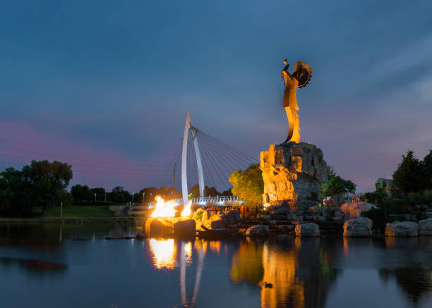 Wichita, Kansas, USA - August 13, 2017: Keeper of the Plains steel sculpture on the Arkansas River Lighting of the flames at the Keeper of the Plains steel sculpture on the Arkansas River wichita photos stock pictures, royalty-free photos & images