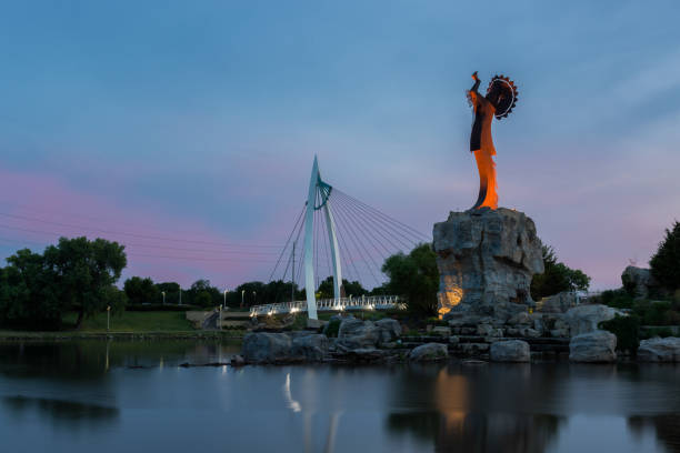 Wichita, Kansas, USA - August 13, 2017: Keeper of the Plains steel sculpture on the Arkansas River Keeper of the Plains steel sculpture on the Arkansas River at dusk wichita photos stock pictures, royalty-free photos & images