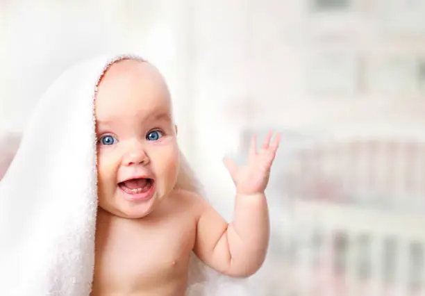 Photo of Baby in towel on blur background.