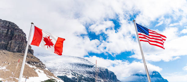 istock US and Canadian flags in Logan Pass 860236208