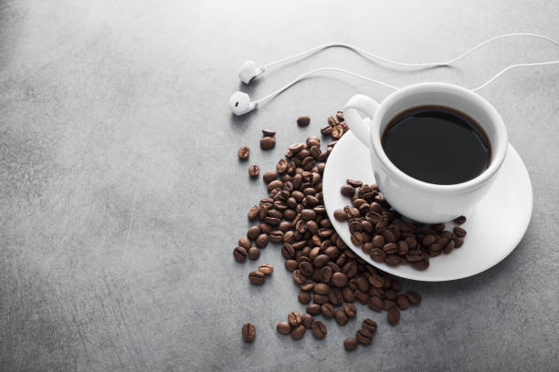 istock White cup of coffee with headphone and coffee beans 860236304