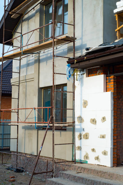 istock Reconstruction of private house, installing thermal insulation for walls with scaffoldings 860236452