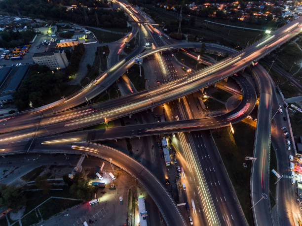 istock Vertical top down aerial view of traffic on freeway interchange at night. 860236860