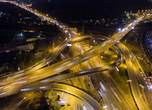 istock Vertical top down aerial view of traffic on freeway interchange at night. 860237004