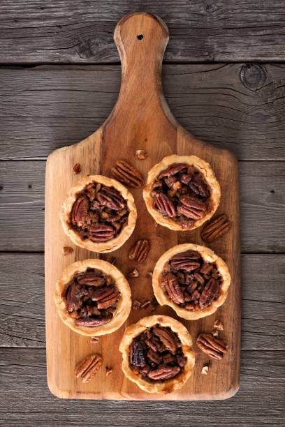 istock Pecan pie tarts on a wooden paddle board 860239348