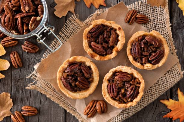 istock Pecan tarts above scene on rustic wood 860239414