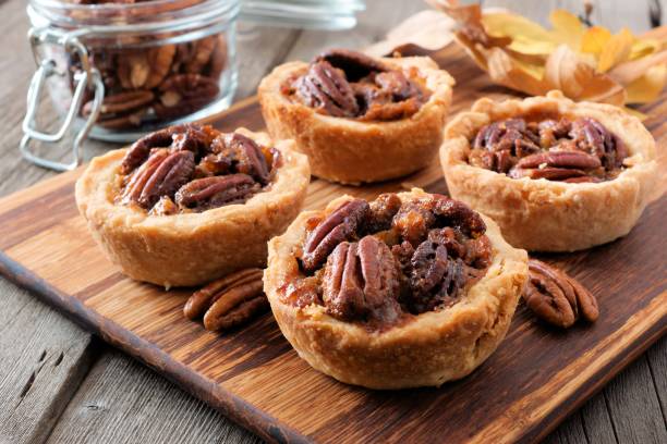 istock Pecan tarts close up on a wooden server 860239476