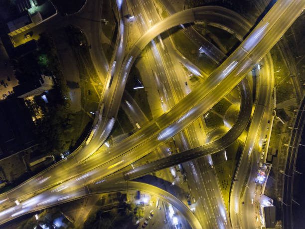 istock Traffic on freeway interchange. Aerial night view city traffic. 860239492