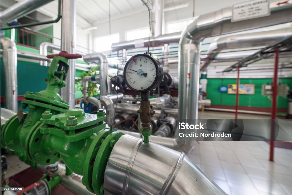 Round mechanical pressure gauges on pipelines Round mechanical pressure gauges on pipelines. Modern industrial boiler room. Order Stock Photo