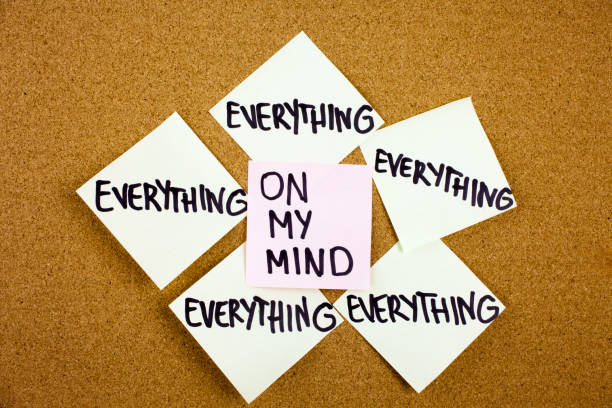 istock A yellow sticky note writing, caption, inscription Phrase everything on my mind in black ext on a white sticky note pinned to a cork notice board 860243638