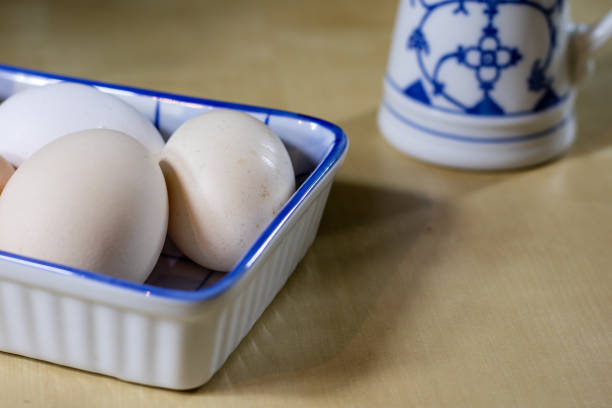 istock Egg, milk and jug on the kitchen table. Kitchen table with food products. Black background. 860246110