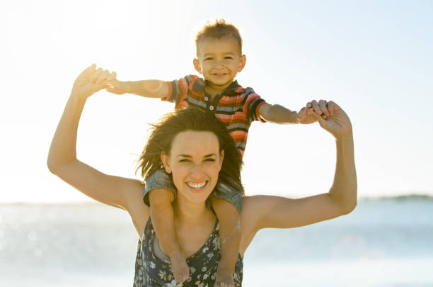 istock Mother and son having fun at the beach 860246676