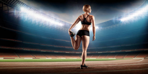 istock muscular female athlete stretching on stadium with running track 860246726