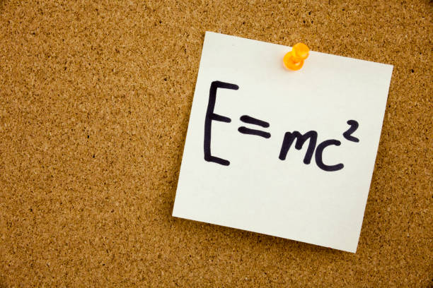 istock A yellow sticky note writing, caption, inscription EQUATION E EQUAL MC2 in black ext on a sticky note pinned to a cork notice board 860247164